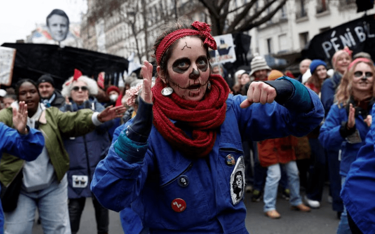 Femimist activists dressed as Rosie the Riveter icon perform during a demonstration against French government’s pension reform plan in Paris as part of a day of national strike and protests in France on Thursday. — Reuters